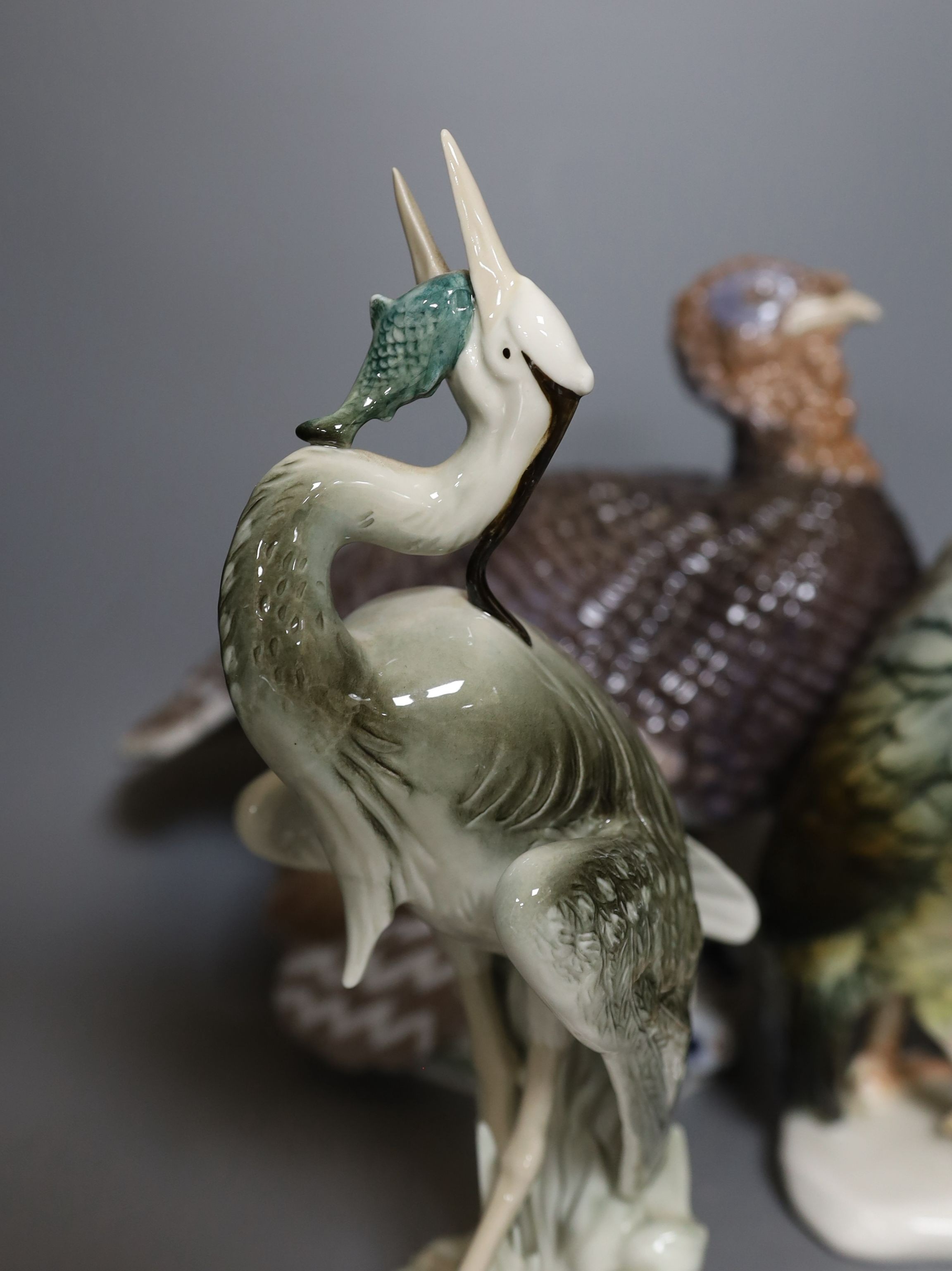 A Rosenthal porcelain model of two guinea fowl, impressed model number 205, a Bing & Grondahl limited edition model of a turkey, no.31 of 750, model 2426 or 2727, a Royal Dux porcelain model a heron and a Karl Ens group